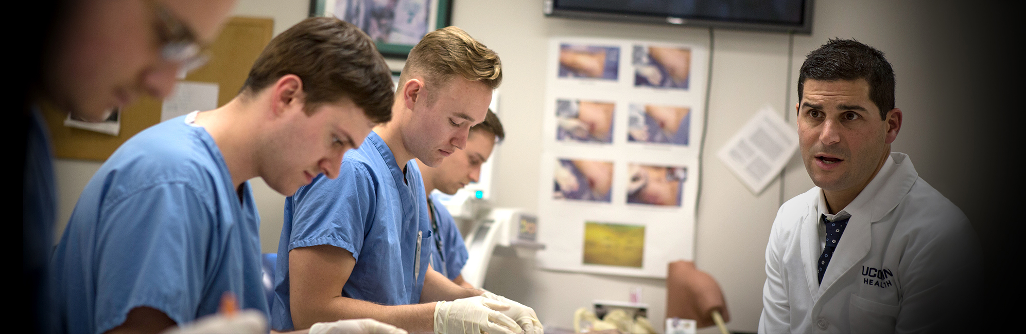 students in scrubs are guided by lab professional