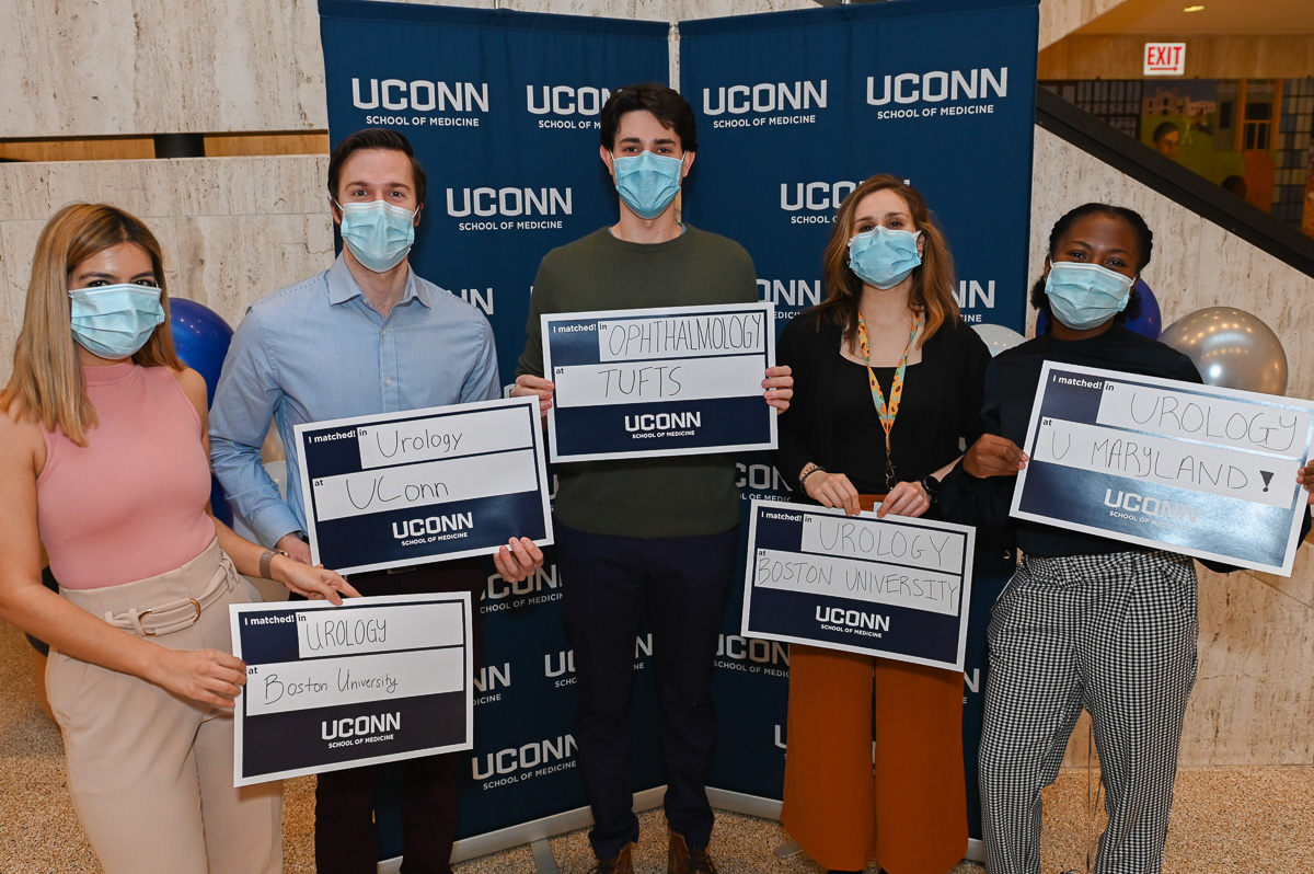 Fourth-year medical students celebrating their early-matches to residency programs in the Academic Lobby on Feb. 8, 2022. Pictured from left to right: Rhea Sindvani, Ryan Daigle, Simon Archambault, Jessa Sahl, and Tijesunimi (TJ) Oni of UConn School of Medicine (UConn Health photo/Tina Encarnacion).